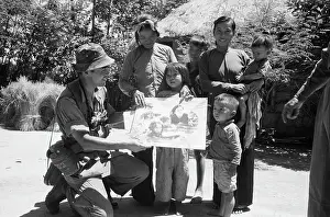 Photographer Kyoichi Sawada Presenting Prize Winning Photo to Villagers