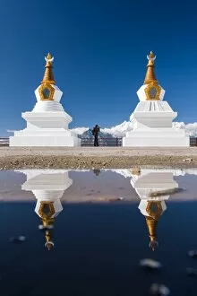 A photographer with tibetan stupas