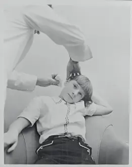 Physician Examining a Young Girl's Ear for Hearing Aid