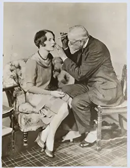 Caution Prints: Physician Using Early Technique to Examine Female's Eyes