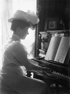 Prints of A woman wearing a hat and playing an upright piano. (Photo by F J Mortimer/Getty Images) Francis James Mortimer (1874-1944) Prints: Pianist With Hat