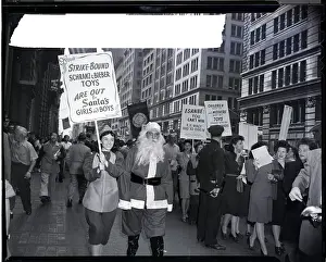 Striking Prints: Picketers Picket with Man Dressed as Santa Claus