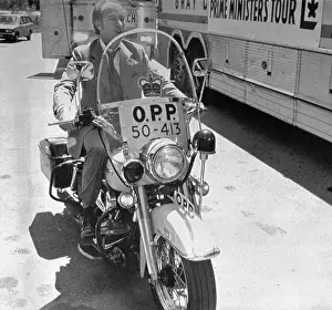 Pierre Trudeau on Motorcycle by Campaign Bus