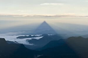 Images Dated 16th November 2012: Pilgrim mountain, sun creating a triangle shadow in the landscape, image of God, Buddhist temple