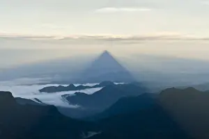 Misty Prints: Pilgrim mountain, sun creating a triangle shadow in the landscape
