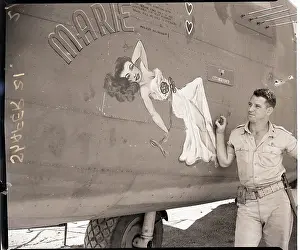 Sticker Prints: Pilot Admiring Decal of Woman on Plane