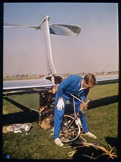 Pilot Inspecting Damaged Front of Experimental Glider