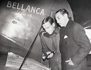 Pilots Reading Newspaper on the Wing of a Plane