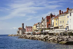 Piran lighthouse and houses at the waterfront