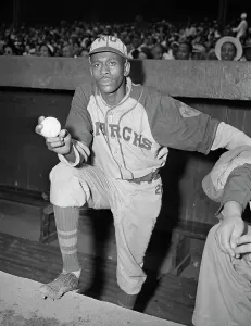 Dugout Prints: Pitcher Satchel Paige Standing in Dugout