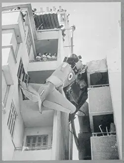 Plane Wreckage Caught Between Buildings