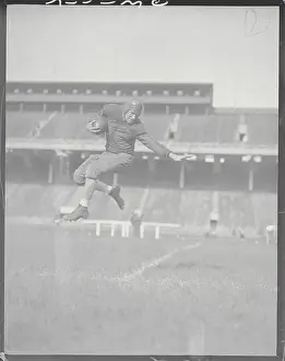 Lancaster Prints: Player Soaring Through Air with Football