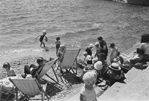 Prints of 19th July 1941: People on the beach in Plymouth on the south coast of England. Original Publication: Picture Post - In Plymouth Life Goes On - pub Discover the Vision of Haywood Magee – A Master of Mid-Century British Life: Plymouth Beach