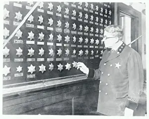 Police Chief Holding Badge