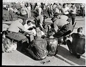 Grabbing Prints: Police Grabbing Oil-Covered Picketers