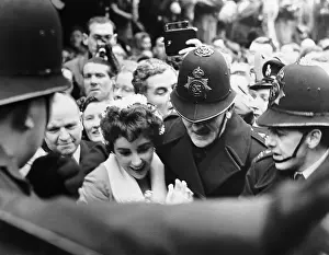 Police Help Liz Taylor Through Crowd