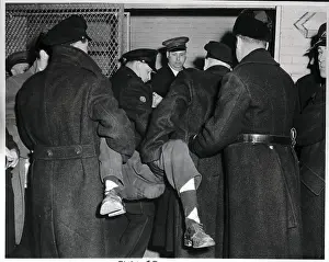 Prints of (Original Caption). Here, police are loading one of the infuriated fans into the paddy wagon as the law broke up the riot that stopped the Montreal-Detroit hockey game at Montreal's Forum last night Frozen Moments: A Journey Through Hockey History: Police Load People into Paddy Wagon