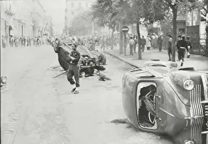 Police near Overturned Cars and Congregation During Riot