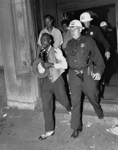 Injury Prints: Police Officer Leading Injured Man