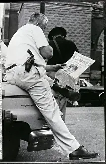 Montgomery Prints: Police Officer Reading Newspaper