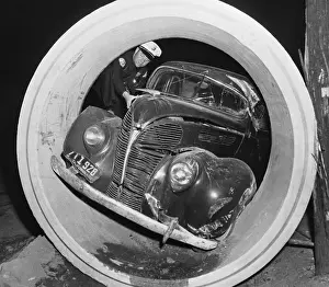 Disrepair Prints: Police Officer Viewing Automobile Lodged In Drain Pipe