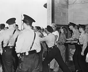 Restraining Prints: Police Restrain UAW Pickets at Garage