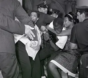 Discrimination Prints: Police Scuffling with Chained Protesters