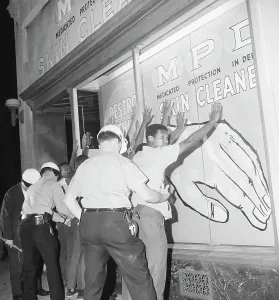 Searching Prints: Police Search Young African American Men During Riot
