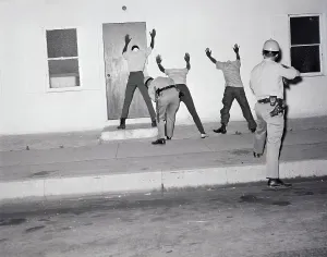 Searching Prints: Police Searching Rioters Against Wall