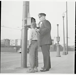 Mischief Prints: Police Using Telephone with Young Suspect in Tow