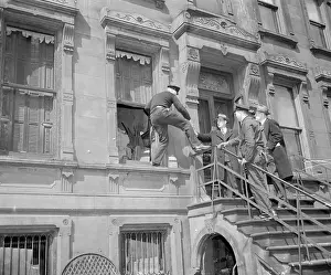 Policeman Climbing From the Front Window of a House