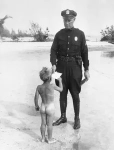 Nude Prints: Policeman giving card to naked boy