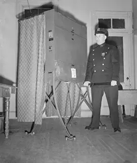 Policeman Guarding Voting Booth
