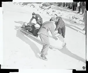 Policeman Helping Edgar Seymour Out of a Bobsled