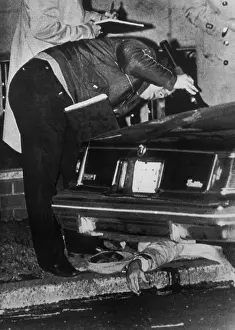 Policeman Inspecting a Car