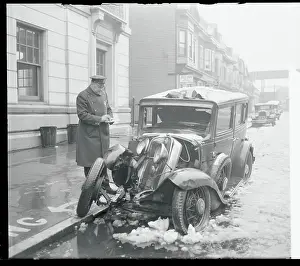 Policeman Inspecting a Wrecked Car
