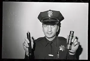 Policeman with New Type of Mace