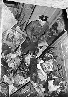 Messy Prints: Policeman Searching Through Debris in Mansion