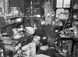Window Prints: Policeman Searching Littered Kitchen of Ed Gein