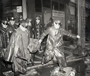 Policemen Carrying Body on Street