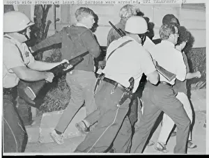 Policemen with Guns Arresting Youth Protesters