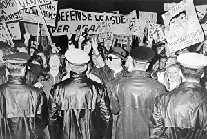 Policemen Holding Back Large Crowd