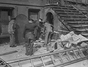 Policemen Trying to Enter a House Through a Basement Doorway