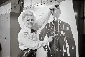 Policewoman Pointing out Target for Firearms Training