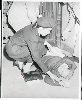 Policewoman Trying to Revive a Fainted Woman