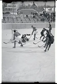 Prints of 2/5/1932-Lake Placid, NY-ORIGINAL CAPTION READS: A player for the American hockey team (3) passes the puck in Team USA's game against the Polish team at the Third Olympiad Frozen Moments: A Journey Through Hockey History: Polish and U.S.A. Man Passing Puck During Olympic Hockey Game