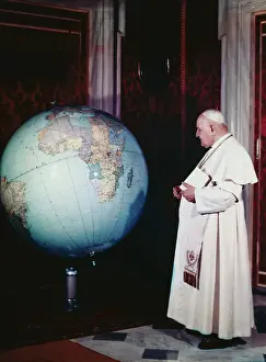Pope John XXIII Looking at Globe