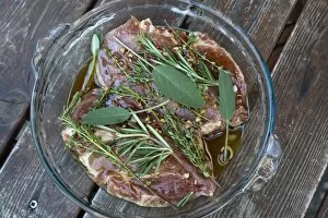Images Dated 6th September 2016: Pork neck steaks in marinade with herbs