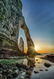 Seashore Prints: The Porte D'Aval rock formation in Etretat, France during the sunset