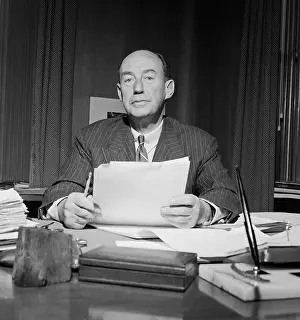 Portrait of Adlai Stevenson Standing and Holding His Eyeglasses